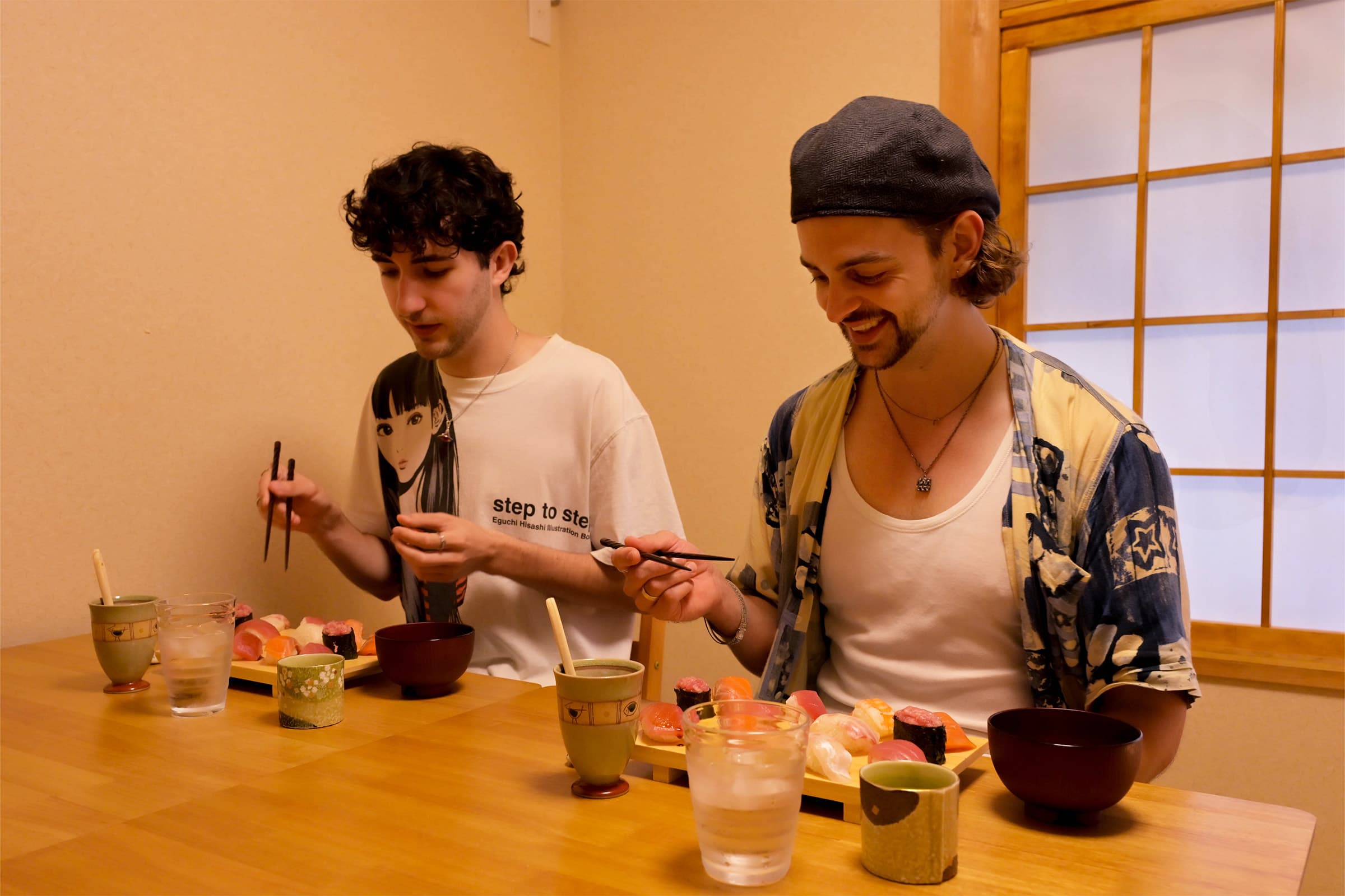 Guests smiling together while eating the sushi they made